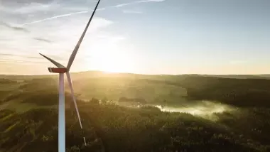 A mountain town viewed from the position of a wind turbine in the hills